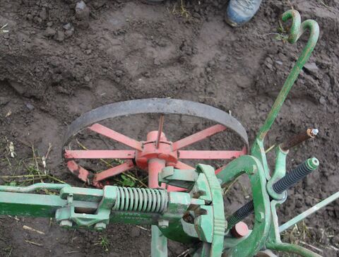 mittig: Grundeinstellung zwischen den Fixierböcken für den Pflugbaum die nach Bedarf (z.B. Hanglage) verstellt werden können; Kurbel für Furchentiefe