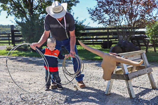 ITLA board member Gary Lake adds the professional touch to a younger cowhand in preparation for the National Finals.